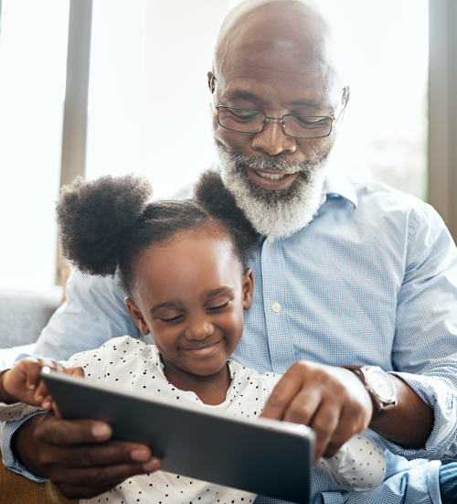 Grandfather reading to granddaughter about The Masters Plan